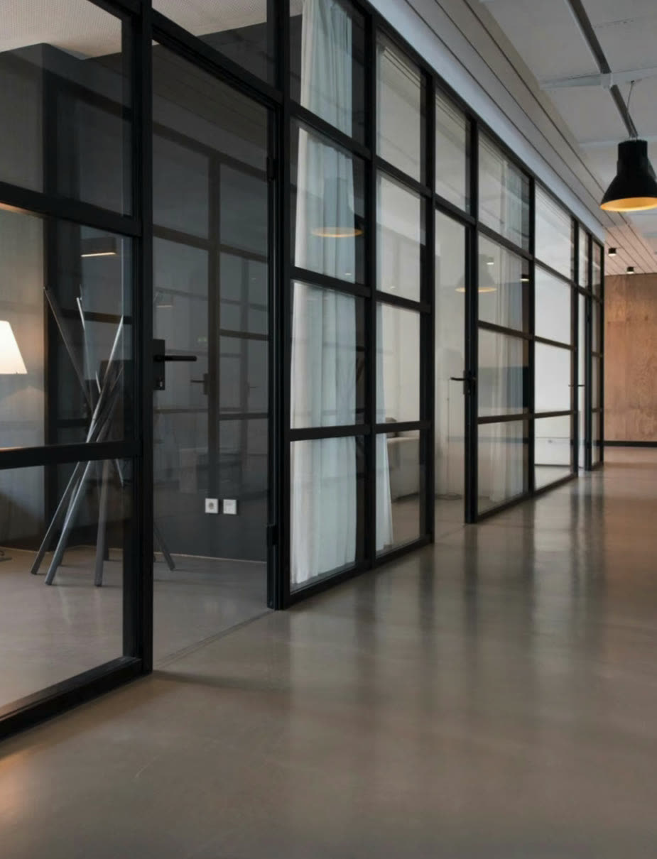 Glass-walled office corridor